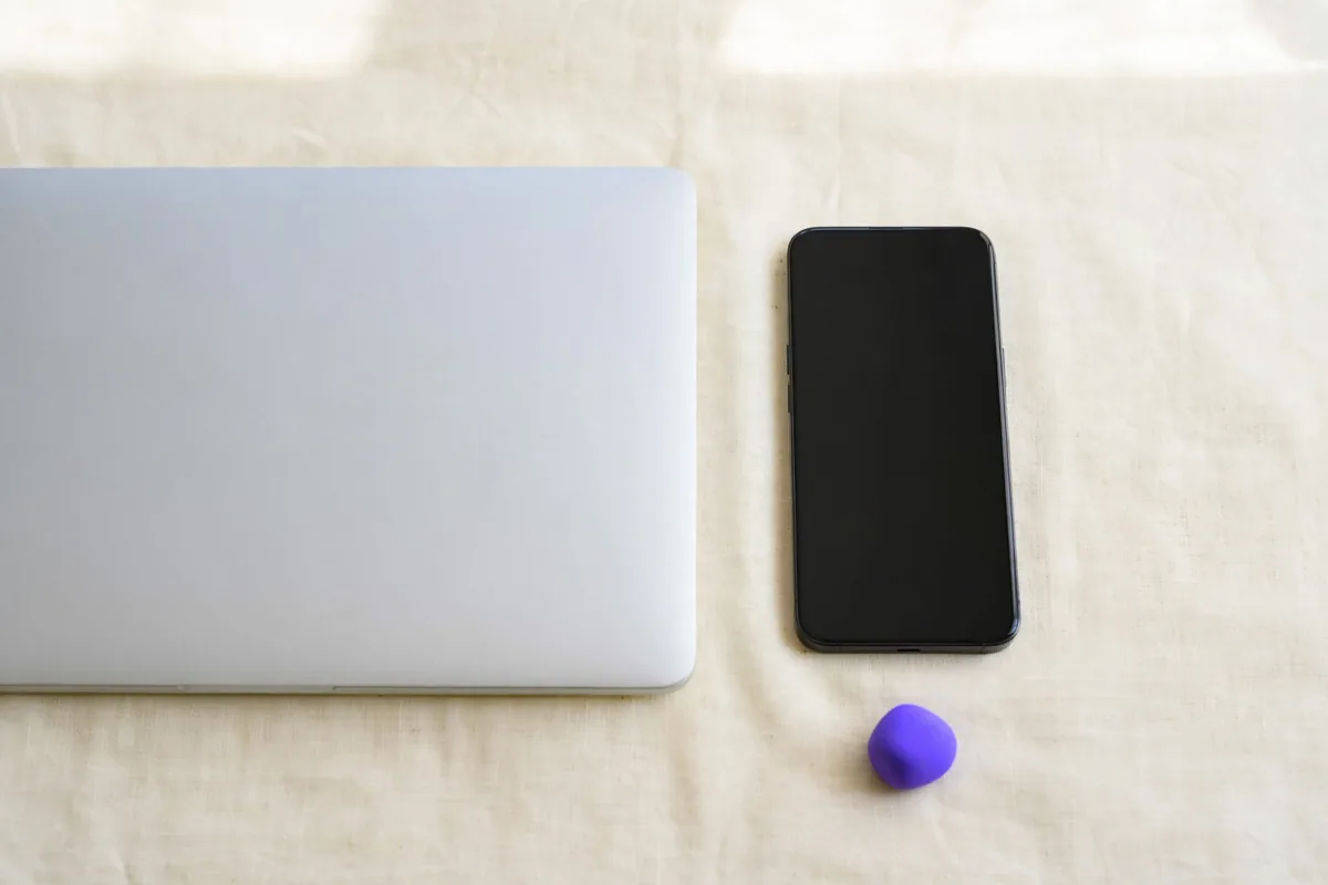 A phone and a laptop side by side