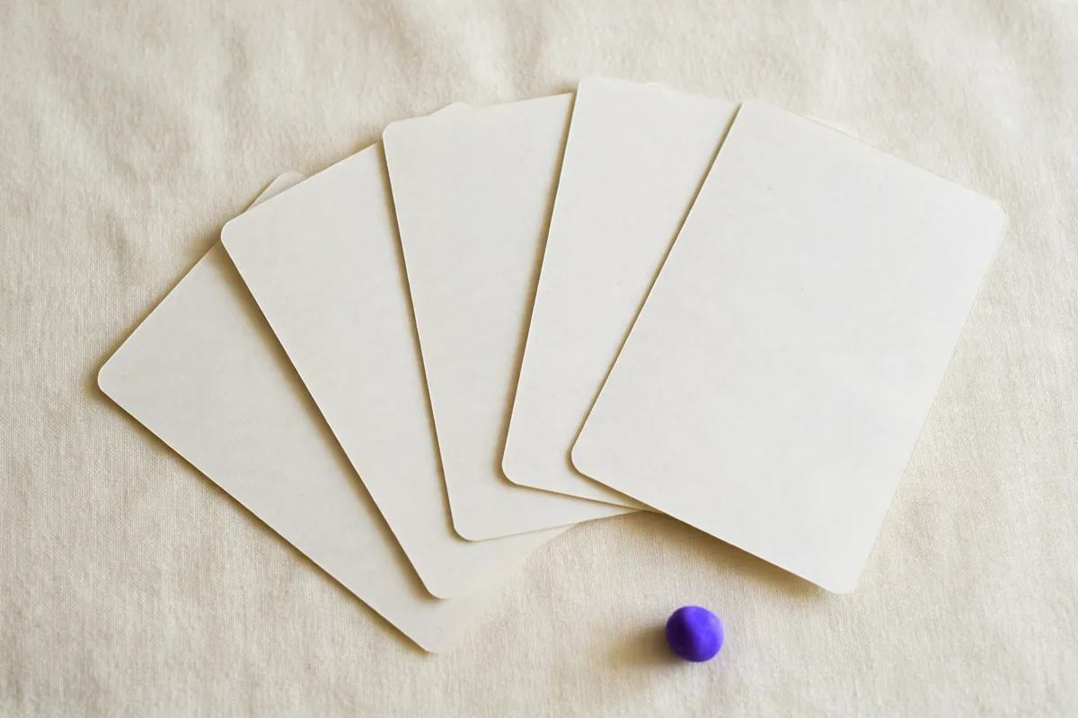 Several blank paper index cards fanned out